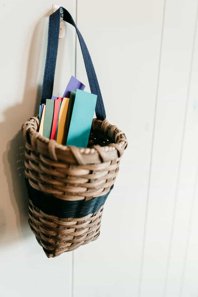 Hanging basket with strips of colorful paper in it.