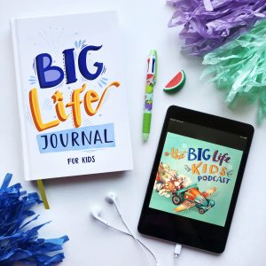 Big Life Journal laying on table with pencil and iphone with headphones